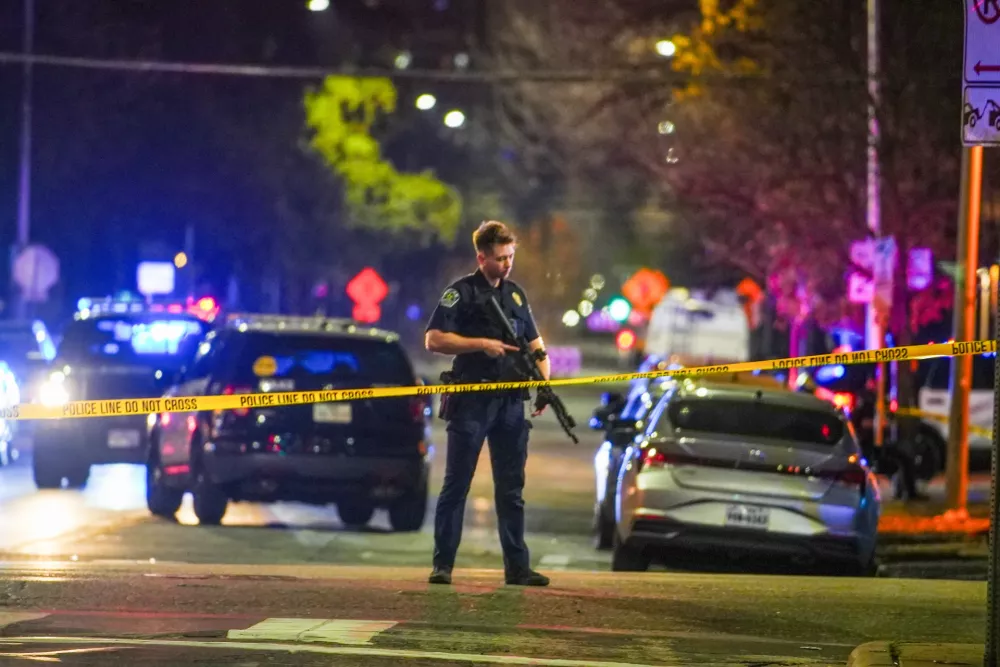 An Austin police officer guards the scene on West 6th Street at West Avenue after a shooting, Sunday March 1, 2026, in Austin, Texas. (Ricardo B. Brazziell/Austin American-Statesman via AP)