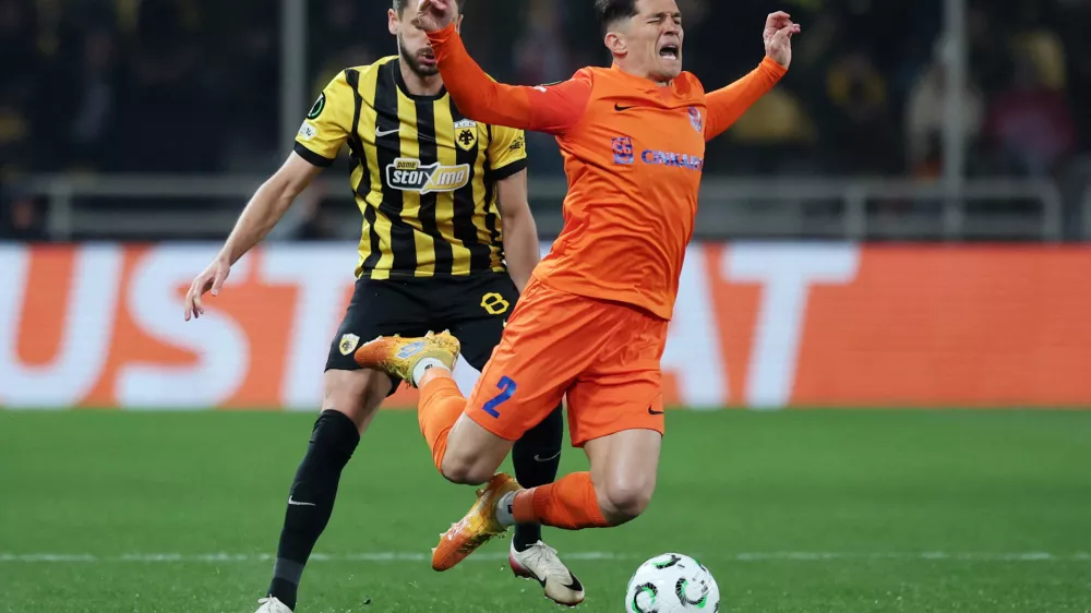 Soccer Football - UEFA Conference League - Round of 16 - Second Leg - AEK Athens v Celje - AEK Arena, Athens, Greece - March 19, 2026 NK Celje's Juanjo is fouled by AEK Athens' Mijat Gacinovic REUTERS/Alkis Konstantinidis