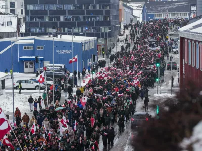 FILE - A crowd walks to the U.S. Consulate to protest against President Trump's policy towards Greenland, Saturday, Jan. 17, 2026, in Nuuk, Greenland. (AP Photo/Evgeniy Maloletka, File)