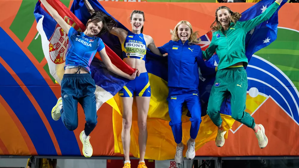 Angelina Topic, of Serbia, Yaroslava Mahuchikh, of Ukraine, Yuliia Levchenko, of Ukraine, and Nicola Olyslagers, of Australia, from left, jump for a winners photo after the women's high jump final at the World Athletics Indoor Championships in Torun, Poland, Friday, March 20, 2026. (AP Photo/Matthias Schrader)