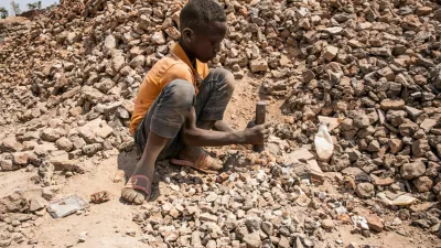 Children work in an aggregate mining site, Kolwezi. As a climate emergency approaches, industries across the world slowly begin to adapt and change. Demand soars for materials needed for renewable technologies, with cobalt and copper more essential than ever for use in electric vehicle batteries and other cutting-edge applications. Around two thirds of Earth's deposits of the ores that contain cobalt, as well as vast reserves of copper, are found in the dusty southern provinces of the Democratic Republic of Congo. With a renewed interest from the global community, billions of dollars flow in and out of Congo. Multinational companies vie for rights to mineral deposits and Congolese politicians create a fruitful niche for themselves in the sale of contracts and site access around the mining town of Kolwezi. Little of this wealth comes to those who live and work here, as communities find themselves exploited, poisoned and excluded from the riches of the green minerals of the electric future.,Image: 804607234, License: Rights-managed, Restrictions:, Model Release: no
