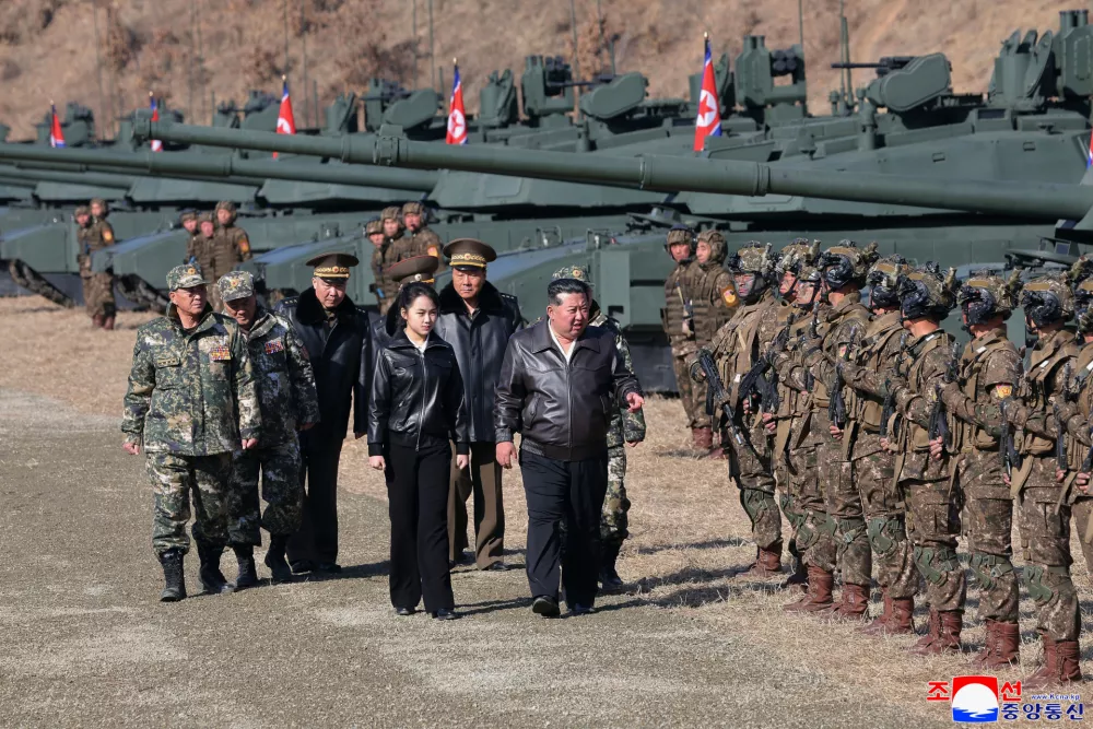 In this photo provided by the North Korean government, its leader Kim Jong Un, center, and his daughter, reportedly named Kim Ju Ae, visit a military training base in North Korea, Thursday, March 19, 2026. Independent journalists were not given access to cover the event depicted in this image distributed by the North Korean government. The content of this image is as provided and cannot be independently verified. Korean language watermark on image as provided by source reads: "KCNA" which is the abbreviation for Korean Central News Agency. (Korean Central News Agency/Korea News Service via AP)