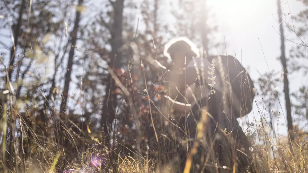 Mature Woman Hiking in Forest Alone.