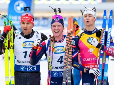From left, second placed Germany's Philipp Nawrath, first placed Johan-Olav Smordal Botn and third placed Eric Perrot from France pose for a photo after the men's 15 km mass start event at the Biathlon World Cup in Holmenkollen, near Oslo, Norway, Sunday, March 22, 2026. (Heiko Junge/NTB Scanpix via AP)