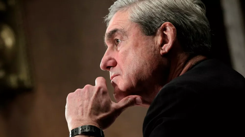 FILE - FBI Director Robert S. Mueller III pauses while testifying before the Senate Judiciary Committee hearing on FBI oversight, Capitol Hill in Washington, Dec. 14, 2011. Mueller died on Friday, March 20, 2026. He was 81. (AP Photo/J. Scott Applewhite, File)