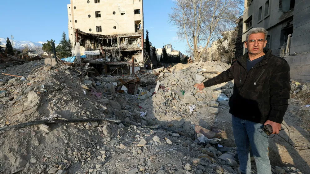 Khalil Mirzahosseini, whose brother Mahdi is missing, gestures during an interview with Reuters at the site of a destroyed building that was damaged by a strike, amid the U.S.-Israeli conflict with Iran, in Tehran, Iran, March 21, 2026. Reuters/Alaa Al-Marjani