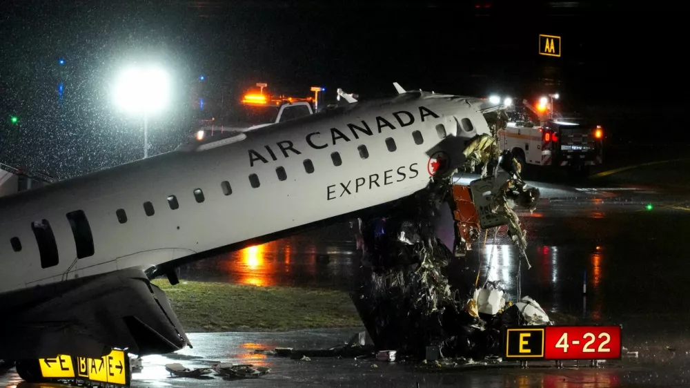 Debris hangs from a damaged Air Canada Express jet that had collided with a fire truck at New York's LaGuardia Airport in Queens, New York, U.S., March 23, 2026. REUTERS/Adam Gray   TPX IMAGES OF THE DAY