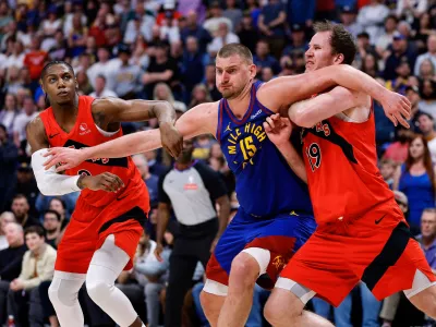 Mar 20, 2026; Denver, Colorado, USA; Denver Nuggets center Nikola Jokic (15) battles for position with Toronto Raptors forward RJ Barrett (9) and center Jakob Poeltl (19) in the fourth quarter at Ball Arena. Mandatory Credit: Isaiah J. Downing-Imagn Images