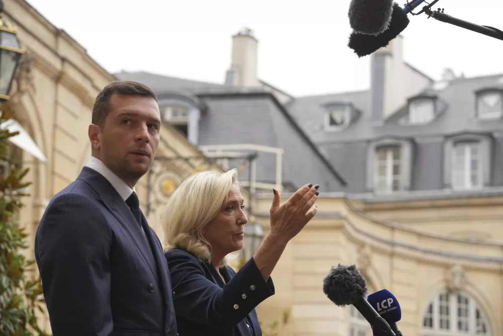 French far right leader Marine Le Pen, right, and Rassemblement National party president Jordan Bardella speak to the media following a meeting with French Prime Minister Francois Bayrou before a confidence vote, at the Hotel Matignon in Paris Tuesday, Sept. 2, 2025. (AP Photo/Thibault Camus)