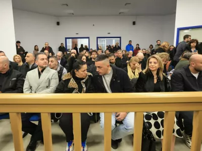 Relatives of victims of the 2023 Tempi train crash, that killed 57 people, wait for the start of the trial in Larissa, Greece, March 23, 2026. REUTERS/Kostas Mantziaris