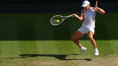 FILE -Iga Swiatek of Poland returns to Amanda Anisimova of the U.S. during the women's singles final match at the Wimbledon Tennis Championships in London, July 12, 2025.(AP Photo/Joanna Chan, File)