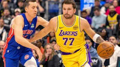 Mar 23, 2026; Detroit, Michigan, USA; Detroit Pistons Duncan Robinson (55) defends against Los Angeles Lakers Luka Doncic (77) during the first quarter at Little Caesars Arena. Mandatory Credit: David Reginek-Imagn Images
