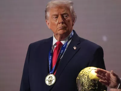 FILE - President Donald Trump stands on stage next to the FIFA World Cup after receiving the FIFA Peace Prize during the draw for the 2026 soccer World Cup at the Kennedy Center in Washington, Dec. 5, 2025. (AP Photo/Jacquelyn Martin, File)