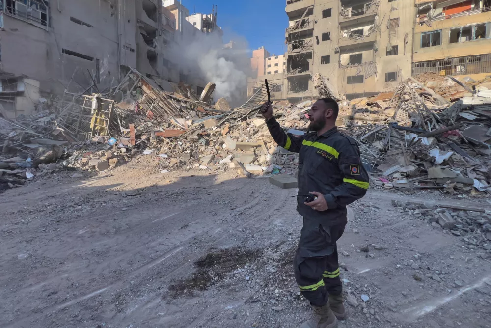 A Civil Defense member works at the site of a destroyed building that was hit by an Israeli airstrike in Dahiyeh, Beirut's southern suburbs, Lebanon, Tuesday, March 24, 2026. (AP Photo/Hussein Malla)