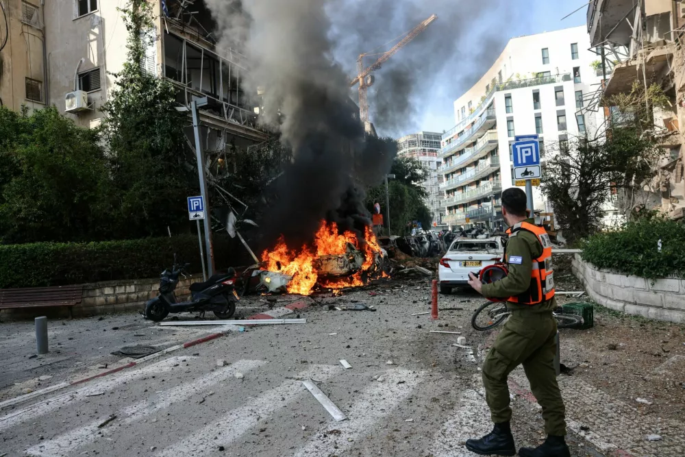 An emergency worker walks at a site following Iranian missile barrages in central Israel, amid the U.S.-Israel conflict with Iran, in Tel Aviv, Israel, March 24, 2026. REUTERS/Tomer Appelbaum ISRAEL OUT. NO COMMERCIAL OR EDITORIAL SALES IN ISRAEL