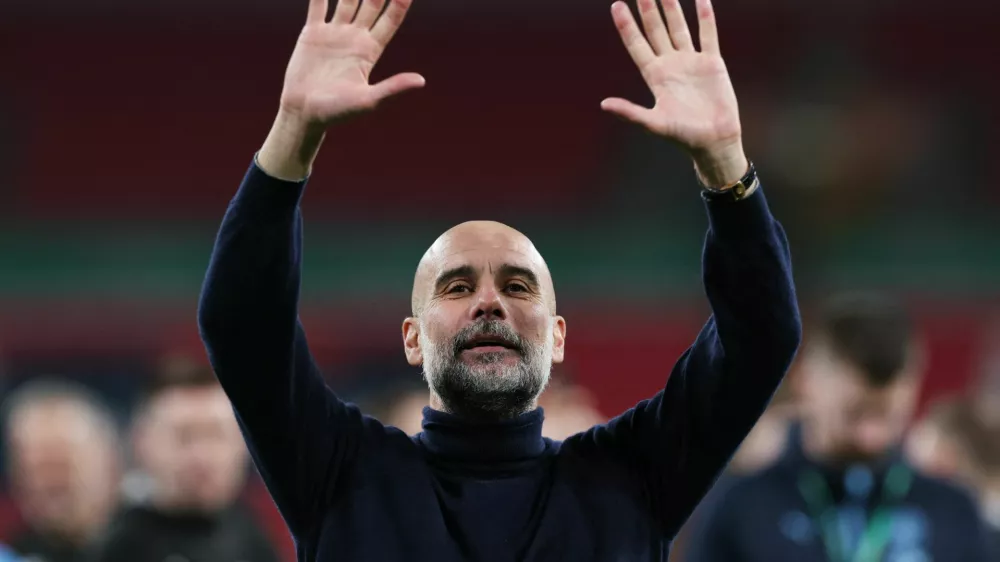 Soccer Football - Carabao Cup - Final - Arsenal v Manchester City - Wembley Stadium, London, Britain - March 22, 2026 Manchester City manager Pep Guardiola celebrates winning the Carabao Cup Action Images via Reuters/Paul Childs EDITORIAL USE ONLY. NO USE WITH UNAUTHORIZED AUDIO, VIDEO, DATA, FIXTURE LISTS, CLUB/LEAGUE LOGOS OR 'LIVE' SERVICES. ONLINE IN-MATCH USE LIMITED TO 120 IMAGES, NO VIDEO EMULATION. NO USE IN BETTING, GAMES OR SINGLE CLUB/LEAGUE/PLAYER PUBLICATIONS. PLEASE CONTACT YOUR ACCOUNT REPRESENTATIVE FOR FURTHER DETAILS..
