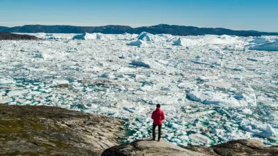 Travel in arctic landscape nature with icebergs - Greenland tourist man explorer - tourist person looking at amazing view of Greenland icefjord - aerial drone image. Man by ice and iceberg, Ilulissat. / Foto: Maridav