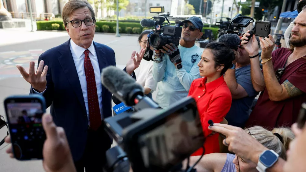 Lawyer Mark Lanier, of the plaintiff Kaley G.M., speaks with members of the media outside court in a key test case accusing Meta and Google's YouTube of harming children's mental health through addictive social media platforms in Los Angeles, California, U.S., March 24, 2026. REUTERS/Caroline Brehman