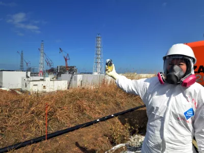A journalist checks radiation level with her dosimeter near stricken Fukushima Dai-ichi nuclear power plant of Tokyo Electric Power Co., during a press tour led by TEPCO officials, in Okuma town, Fukushima prefecture, northeastern Japan Tuesday, Feb. 28, 2012. Japan next month marks one year since the March 11 tsunami and earthquake, which triggered the worst nuclear accident since Chernobyl in 1986. (AP Photo/Yoshikazu Tsuno, Pool)