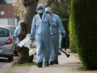 Forensic officers inspect the area at a street near the scene where four ambulances belonging to Hatzola, a Jewish community organisation, were set on fire in an incident that the police say is being treated as an antisemitic hate crime, in northwest London, Britain, March 23, 2026. REUTERS/Isabel Infantes