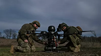 Service members of the 422nd Unmanned Systems Regiment attach a small air bomb to a heavy strike drone before a test flight at a training ground, amid Russia's attack on Ukraine, in Zaporizhzhia region, Ukraine March 23, 2026. REUTERS/Stringer