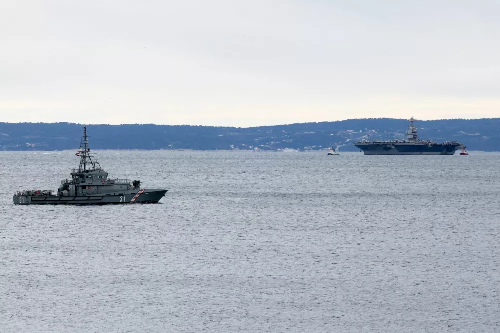 Croatian coastal patrol vessel OOB-31 "OMIS" is seen near U.S. aircraft carrier "Gerald R. Ford" as it arrives in front of Split, in the Adriatic Sea, March 28, 2026. REUTERS/Antonio Bronic