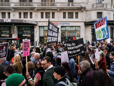 People hold placards and banners during the "Together Against the Far Right" demonstration, in London, Saturday, March 28, 2026.(AP Photo/Alberto Pezzali)