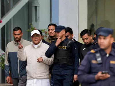 Former Nepal Prime Minister and Chairman of the Communist Party of Nepal (Unified Marxist&ndash;Leninist) K.P. Sharma Oli gestures while being taken to a hospital from the District Police Range after his detention by police, who are investigating whether he was negligent in preventing dozens of deaths during the Gen Z protests, in Kathmandu, Nepal, March 28, 2026. REUTERS/Navesh Chitrakar   TPX IMAGES OF THE DAY   REFILE - CLARIFYING PARTY NAME