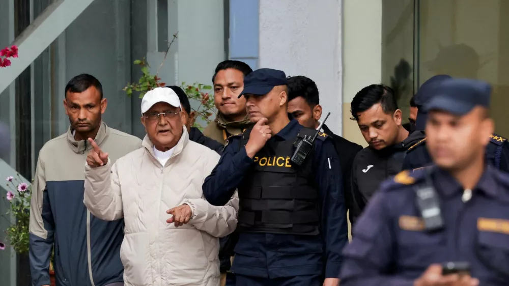 Former Nepal Prime Minister and Chairman of the Communist Party of Nepal (Unified Marxist&ndash;Leninist) K.P. Sharma Oli gestures while being taken to a hospital from the District Police Range after his detention by police, who are investigating whether he was negligent in preventing dozens of deaths during the Gen Z protests, in Kathmandu, Nepal, March 28, 2026. REUTERS/Navesh Chitrakar   TPX IMAGES OF THE DAY   REFILE - CLARIFYING PARTY NAME