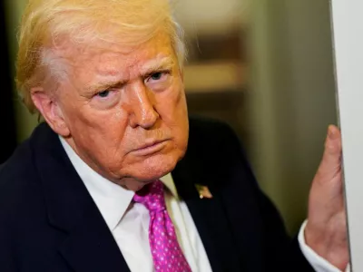 U.S. President Donald Trump looks on as he speaks to members of the media aboard Air Force One en route to Joint Base Andrews, Maryland, U.S., March 29, 2026. REUTERS/Elizabeth Frantz
