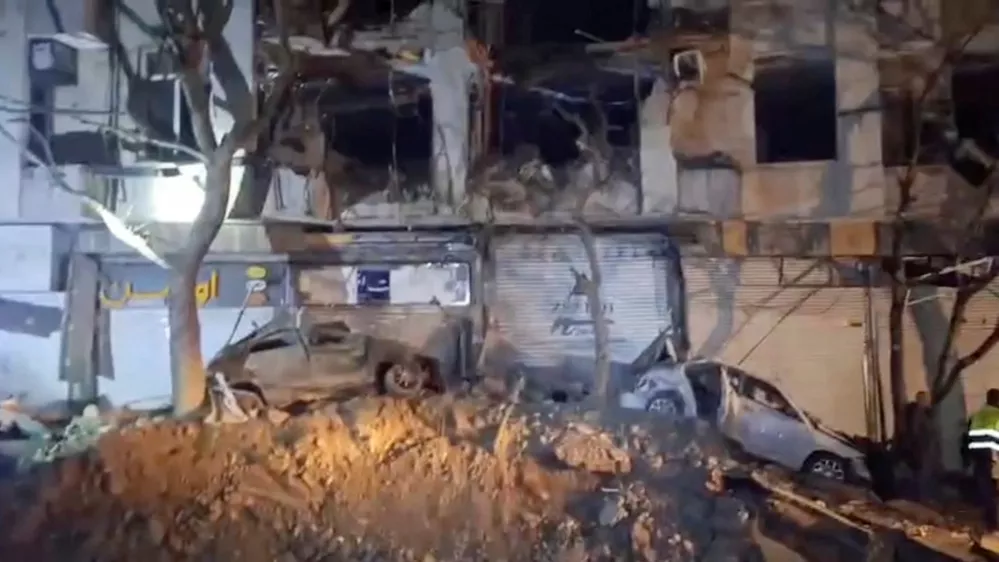 Damage to a building and vehicles in the aftermath of a reported strike, amid the U.S.-Israeli conflict with Iran, in Tehran, Iran, March 28, 2026, in this screengrab from video.  Iranian Red Crescent Society/Handout via REUTERS  THIS IMAGE HAS BEEN SUPPLIED BY A THIRD PARTY. MANDATORY CREDIT. NO RESALES. NO ARCHIVES  VERIFICATION Buildings, business signs and structure matched the file and satellite imagery of the area Date not verified Iranian Red Crescent Society and corroborating reports from Iranian media confirmed the damage on March 28 No old results were found posted online before March 28