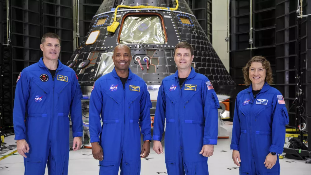 FILE - Artemis II crew members, from left, Jeremy Hansen, Victor Glover, Reid Wiseman and Christina Koch, stand together at NASA's Kennedy Space Center in Florida, in front of an Orion crew module on Tuesday, Aug. 8, 2023. On Tuesday, Jan. 9, 2024, NASA said astronauts will have to wait until 2025 before flying to the moon and another few years before landing on it. (Kim Shiflett/NASA via AP, File)