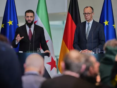 German Chancellor Friedrich Merz, right, and Syrian President Ahmad al-Sharaa attend a press conference in Berlin, Germany, Monday, March 30, 2026. (AP Photo/Markus Schreiber)