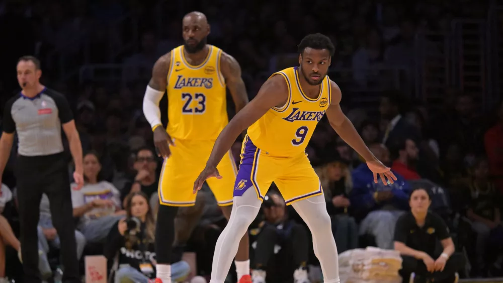 Mar 30, 2026; Los Angeles, California, USA; Los Angeles Lakers guard Bronny James (9) and forward LeBron James (23) defend on the court in the second half against the Washington Wizards at Crypto.com Arena. Mandatory Credit: Jayne Kamin-Oncea-Imagn Images