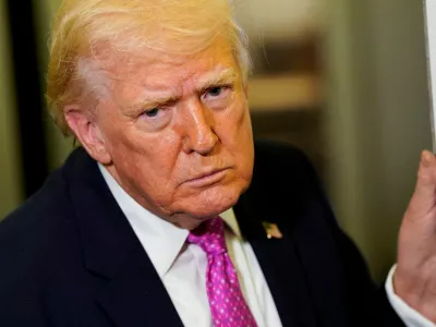 U.S. President Donald Trump looks on as he speaks to members of the media aboard Air Force One en route to Joint Base Andrews, Maryland, U.S., March 29, 2026. REUTERS/Elizabeth Frantz