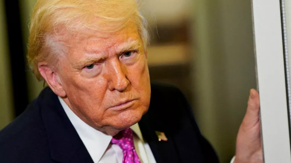 U.S. President Donald Trump looks on as he speaks to members of the media aboard Air Force One en route to Joint Base Andrews, Maryland, U.S., March 29, 2026. REUTERS/Elizabeth Frantz