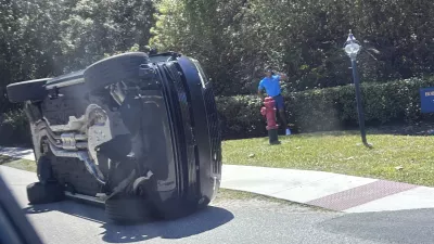 FILE- Golfer Tiger Woods stands by his overturned vehicle in Jupiter Island, Fla., March 27, 2026. (AP Photo/Jason Oteri, File)