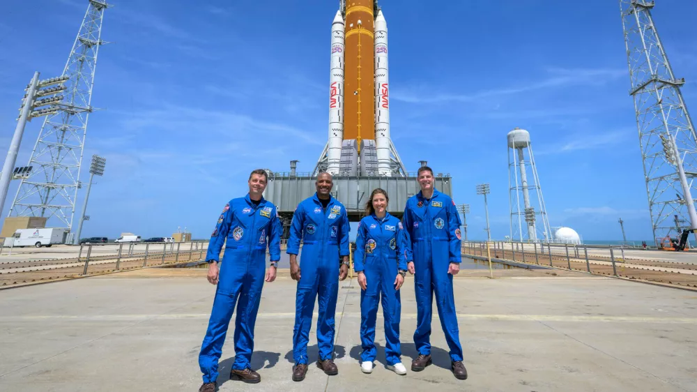This photo provided by NASA shows NASA astronauts Reid Wiseman, Artemis II commander, from left, Victor Glover, Artemis II pilot, Christina Koch, Artemis II mission specialist, and CSA (Canadian Space Agency) astronaut Jeremy Hansen, Artemis II mission specialist, right, in a group photograph as they visit NASA's Artemis II SLS (Space Launch System) rocket and Orion spacecraft, Monday, March 30, 2026, at Launch Complex 39B of NASA's Kennedy Space Center, in Cape Canaveral, Fla. (Bill Ingalls/NASA via AP)