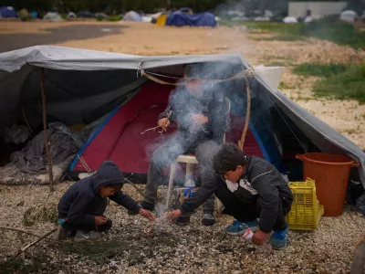 Displaced boys who fled with their family Israeli shelling in southern Lebanon make a bonfire next to their tent used as shelters in Beirut, Lebanon, Wednesday, April 1, 2026. (AP Photo/Emilio Morenatti)