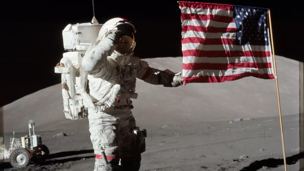 6261520 Astronaut Eugene A. Cernan, Apollo 17 commander, is photographed next to the deployed United States flag during lunar surface extravehicular activity (EVA) at the Taurus-Littrow landing site. The highest part of the flag appears to point toward our planet Earth in the distant background, 1972 (photo). No Use Germany. No Use Italy.