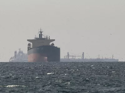 FILE PHOTO: Cargo ships in the Gulf, near the Strait of Hormuz, as seen from northern Ras al-Khaimah, near the border with Oman's Musandam governance, amid the U.S.-Israeli conflict with Iran, in United Arab Emirates, March 11, 2026. REUTERS/Stringer//File Photo