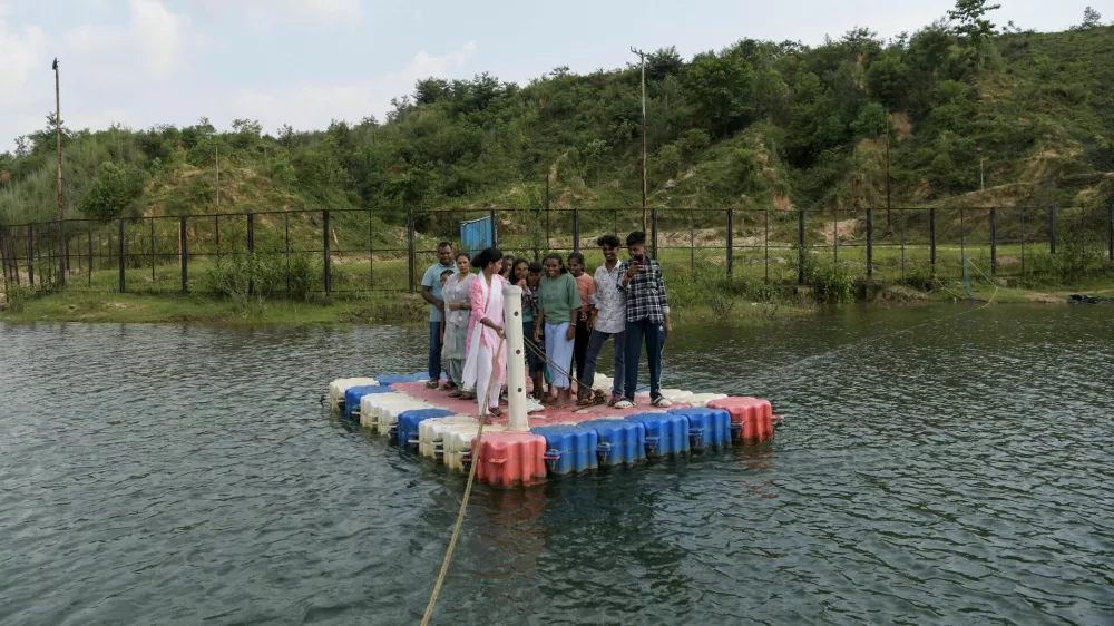 Savita Gupta, 28, brings tourists on a makeshift boat to the floating restaurant run by a self‑help group that she is part of, at Kenapara Eco Park, which was developed from a closed open‑cast coal‑mine pit into a small tourist hub, in Surajpur, India, August 10, 2025. The site, which began to be repurposed for tourism in 2018, is managed by a women's community group and a fishery cooperative, and attracts as many as 150 people at the weekend and, for the women, the gains have gone beyond income. "I hope my daughter will learn from my life and think about becoming an independent woman," Gupta said. REUTERS/Avijit Ghosh   SEARCH "INDIA GHOSH COAL" FOR THIS STORY. SEARCH "WIDER IMAGE" FOR ALL STORIES.  TPX IMAGES OF THE DAY / Foto: Avijit Ghosh