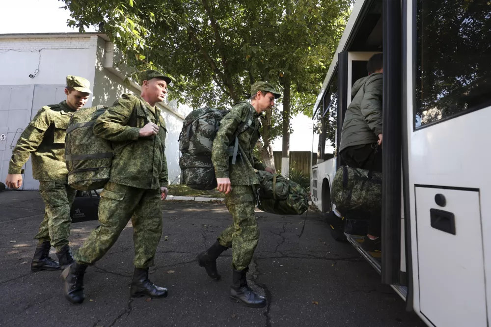 FILE - Russian recruits take a bus near a military recruitment center in Krasnodar, Russia, Sunday, Sept. 25, 2022. Russian President Vladimir Putin on Wednesday ordered a partial mobilization of reservists to beef up his forces in Ukraine. (AP Photo, File)