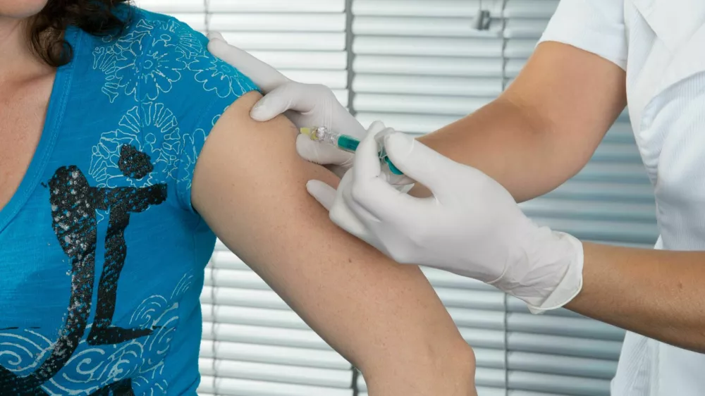 woman doctor vaccine injection with a syringe at hospital