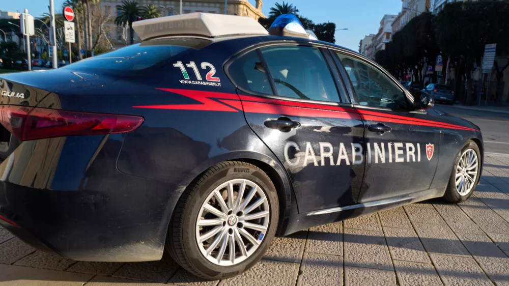 A Carabinieri patrol car is parked along a street in Bari, Italy, on March 24, 2026, with the emergency number 112 visible on the vehicle, indicating law enforcement presence in the city. (Photo by Matteo Della Torre/NurPhoto)NO USE FRANCE