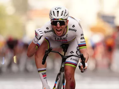 Slovenia's Tadej Pogacar of UAE Team Emirates XRG celebrates after crossing the finish line ahead of Britain's Thomas Pidcock of Pinarello-Q36.5 Pro Cycling Team to win the men's elite race of the Milano-Sanremo one day cycling race (298 km) from Pavia to Sanremo, Italy, March 21, 2026. (Massimi Paolone/LaPresse via AP)