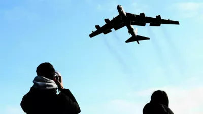 A plane spotter takes pictures as a U.S. Air Force Boeing B-52 Stratofortress takes off at RAF Fairford airbase, used by United States Air Force (USAF) personnel, amid the U.S.–Israeli conflict with Iran, in Fairford, Gloucestershire, Britain, March 15, 2026. REUTERS/Jack Taylo