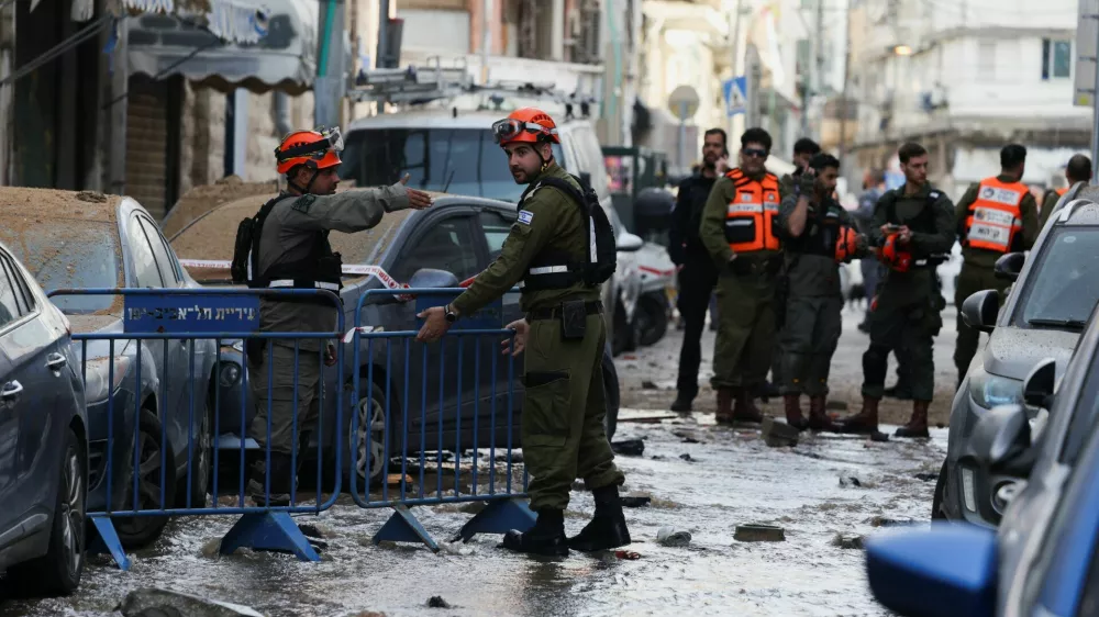 Emergency personnel work next to a damaged building at an impact site, following a barrage of missiles launched from Iran, amid the U.S.-Israeli conflict with Iran, in Tel Aviv, Israel April 6, 2026. REUTERS/Florion Goga