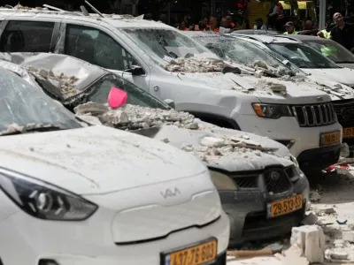 Debris lies on damaged cars at an impact site, following a barrage of missiles launched from Iran, amid the U.S.-Israeli conflict with Iran, in central Israel, April 6, 2026. REUTERS/Nir Elias