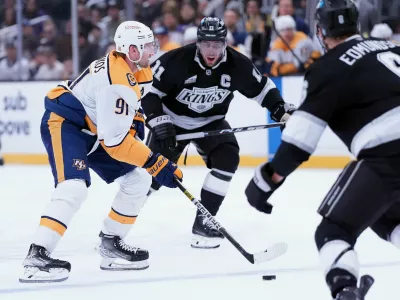Nashville Predators' center Steven Stamkos (91) brings the puck up ice against Los Angeles Kings' center Anze Kopitar (11) during the third period of an NHL hockey game Monday, April 6, 2026, in Los Angeles. (AP Photo/Scott Strazzante)
